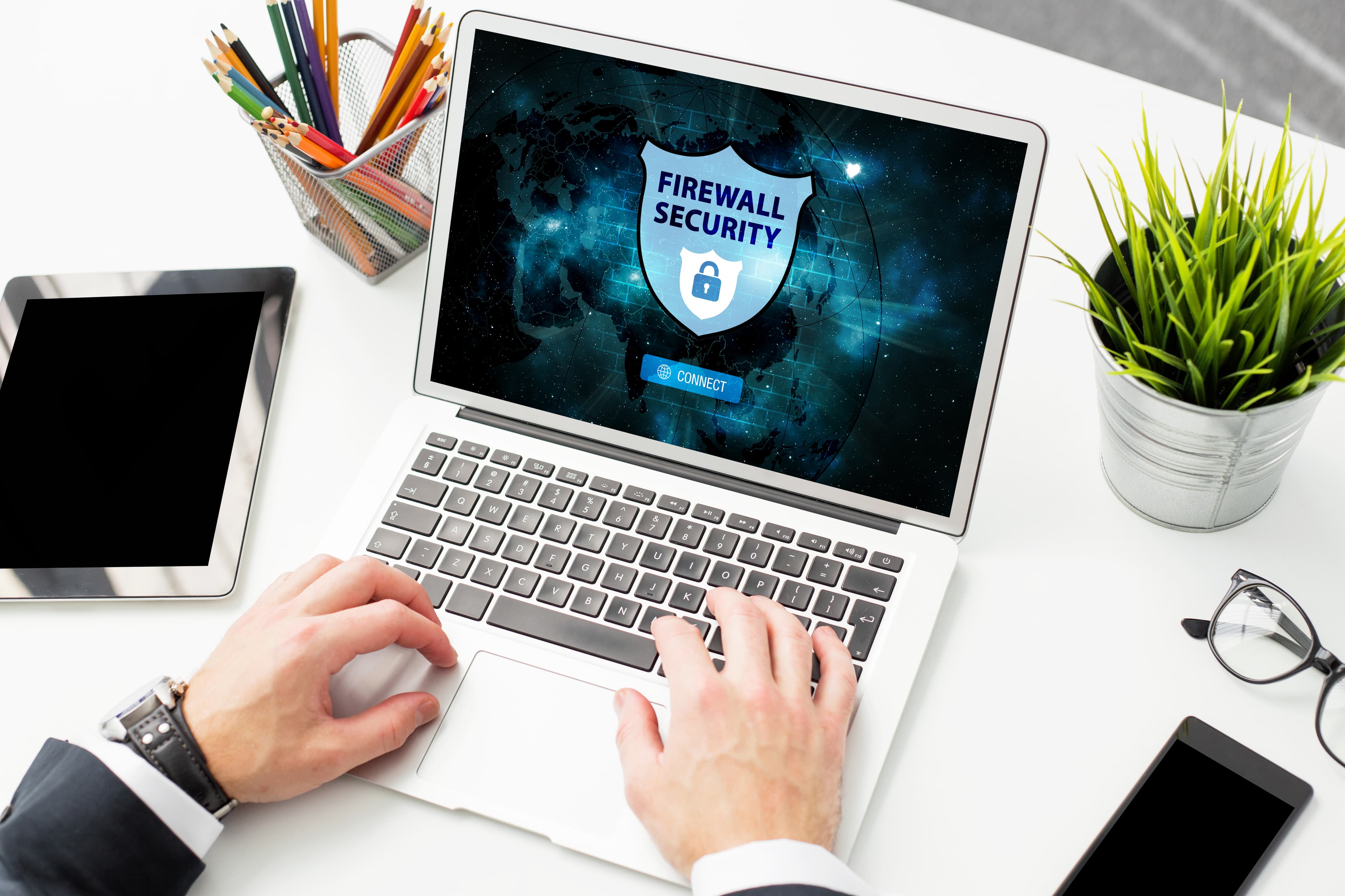 A person using a laptop displaying a cybersecurity interface, relevant to cyber insurance and 2025 Privacy Act amendments.