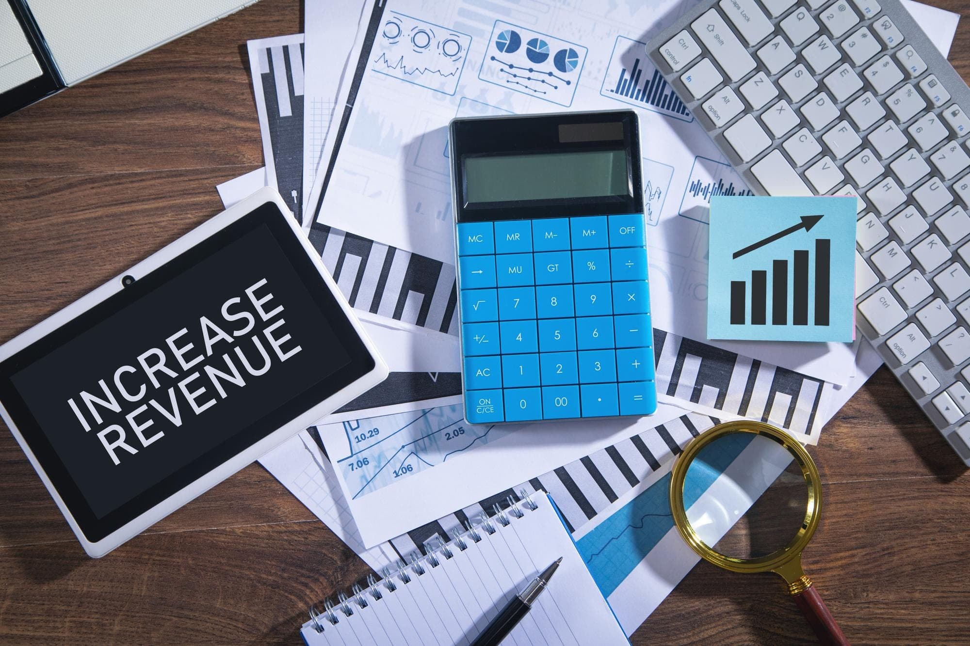 Calculator and charts symbolizing calculating annual turnover for business insurance.
