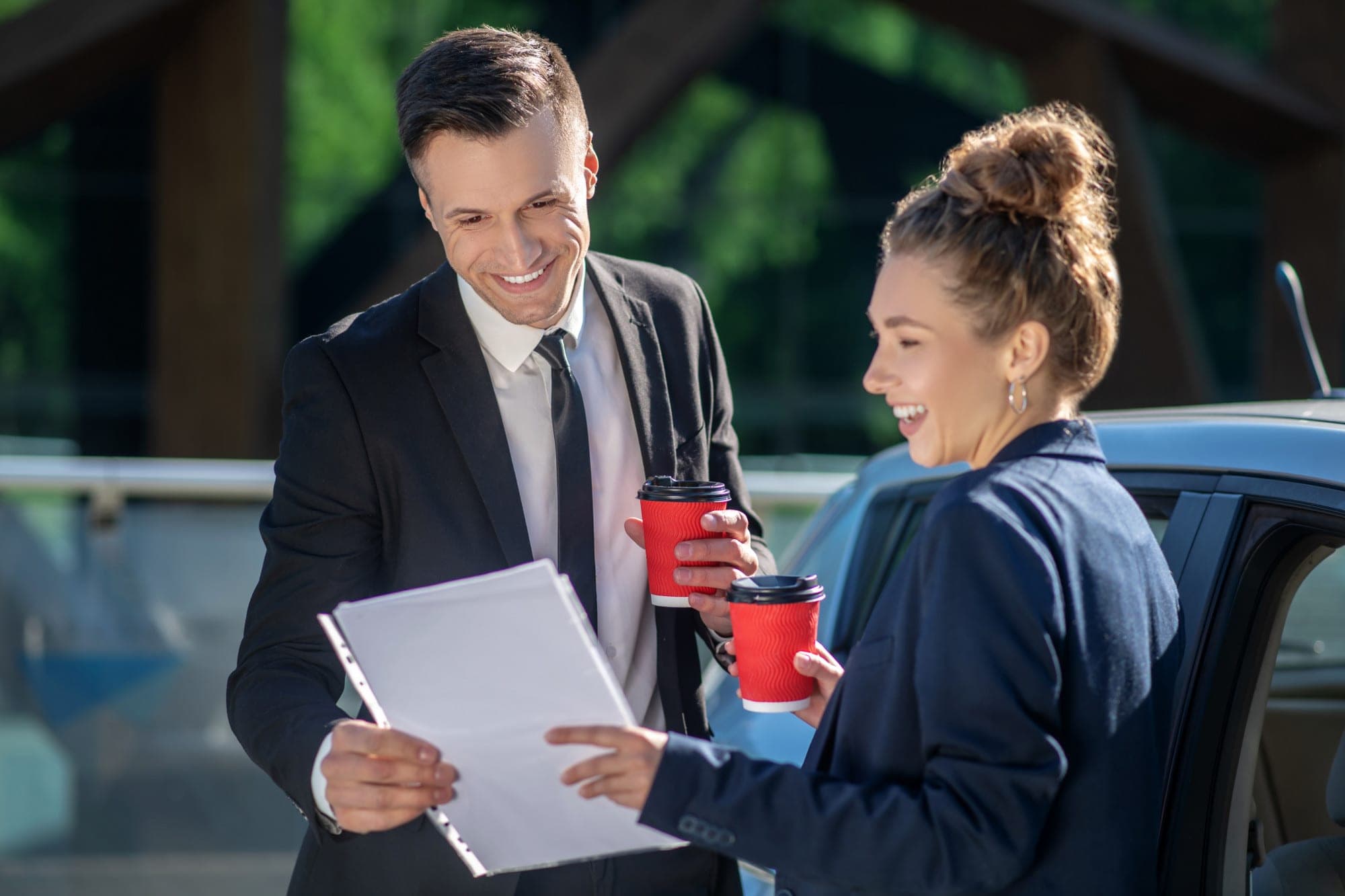 Franchise owner and partner discussing insurance documents outdoors in Australia.