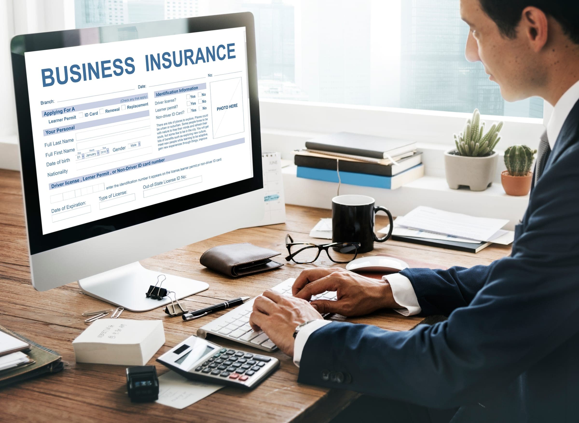 Person reviewing business interruption insurance documents at desk.