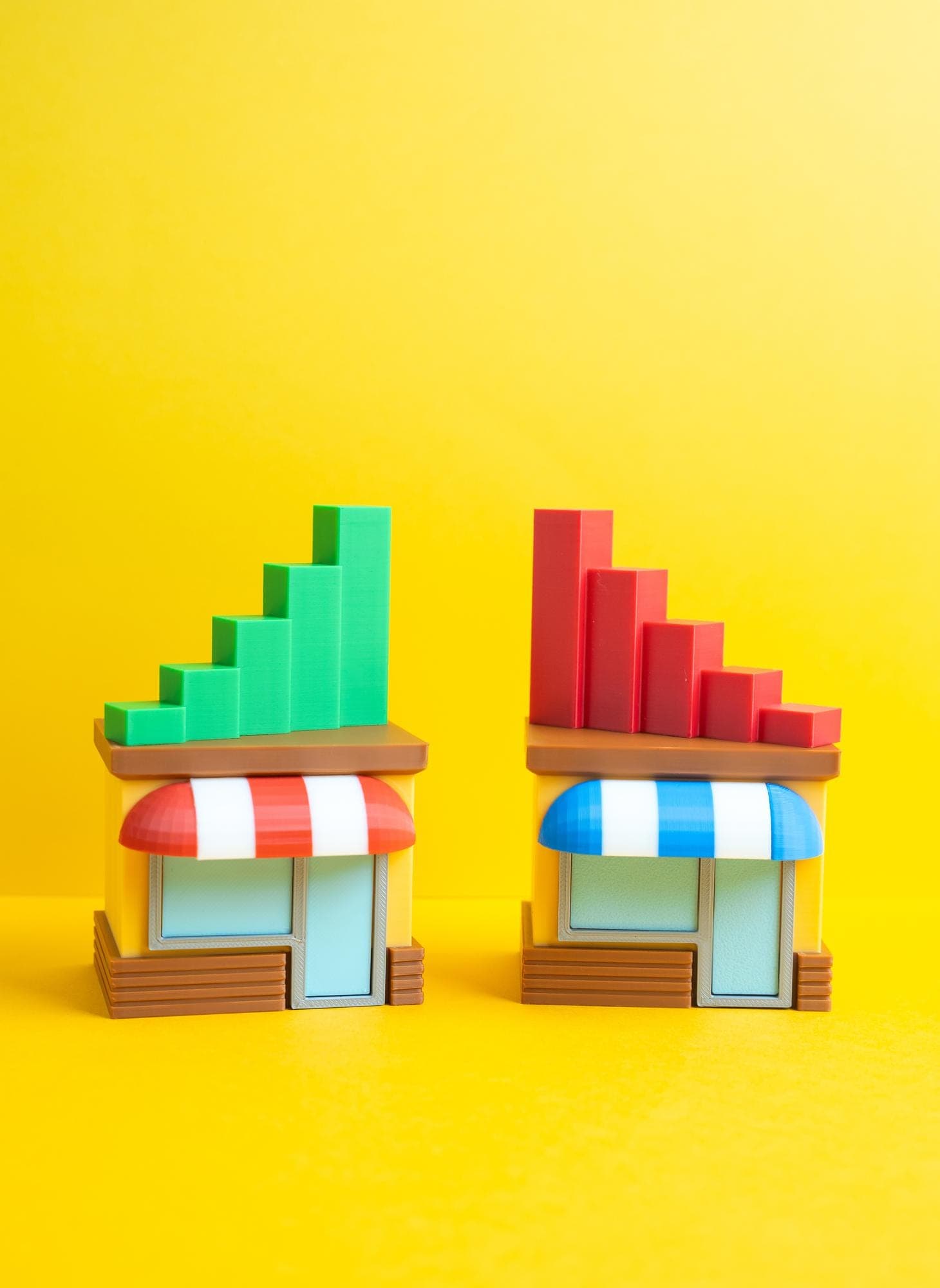 Toy market stalls with rising graph bars symbolizing market stall insurance options.