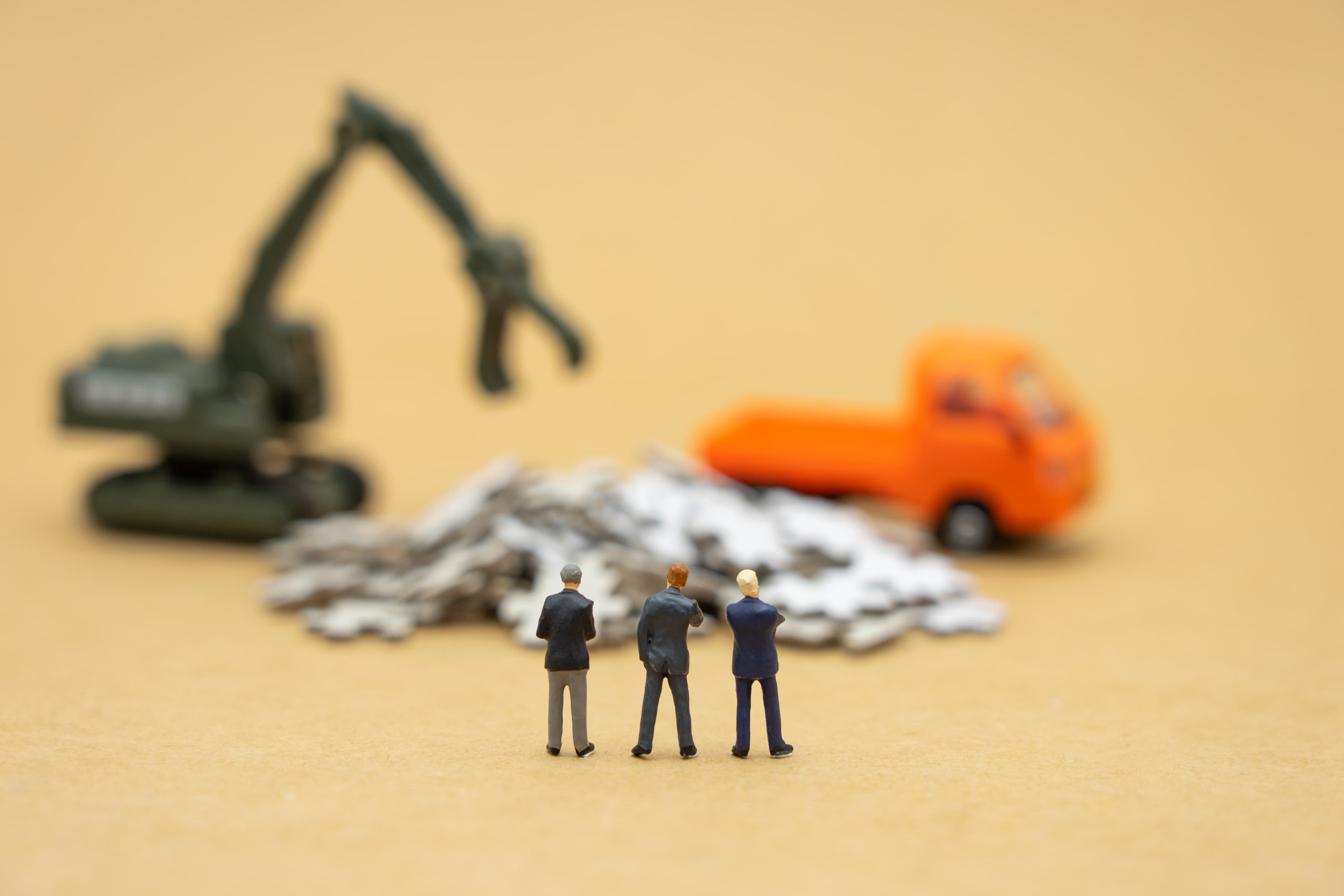 Miniature figures observe hired-in machinery symbols on plant equipment insurance.