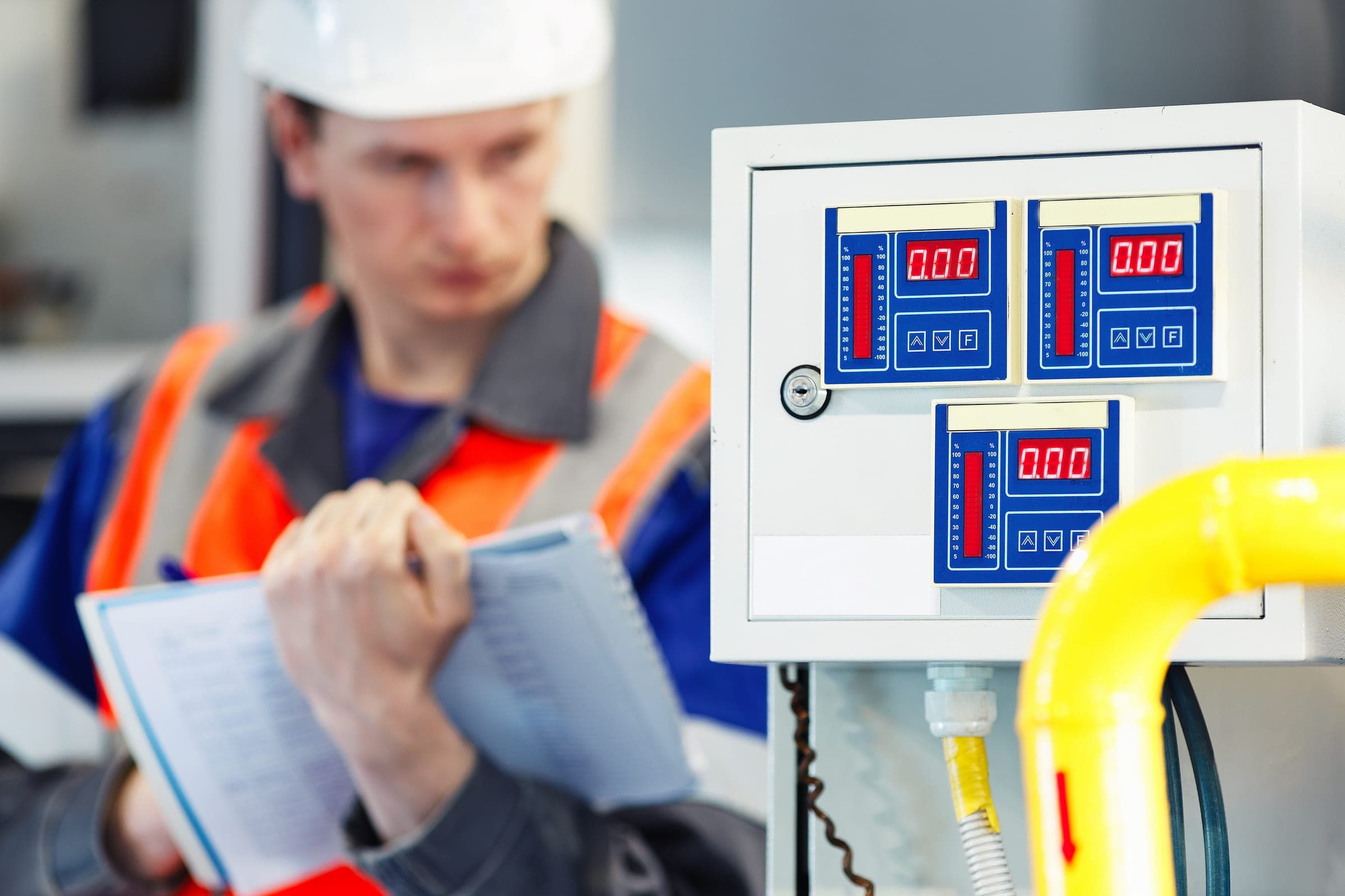 Electrician inspecting equipment for Queensland contractor licence and test and tag compliance.