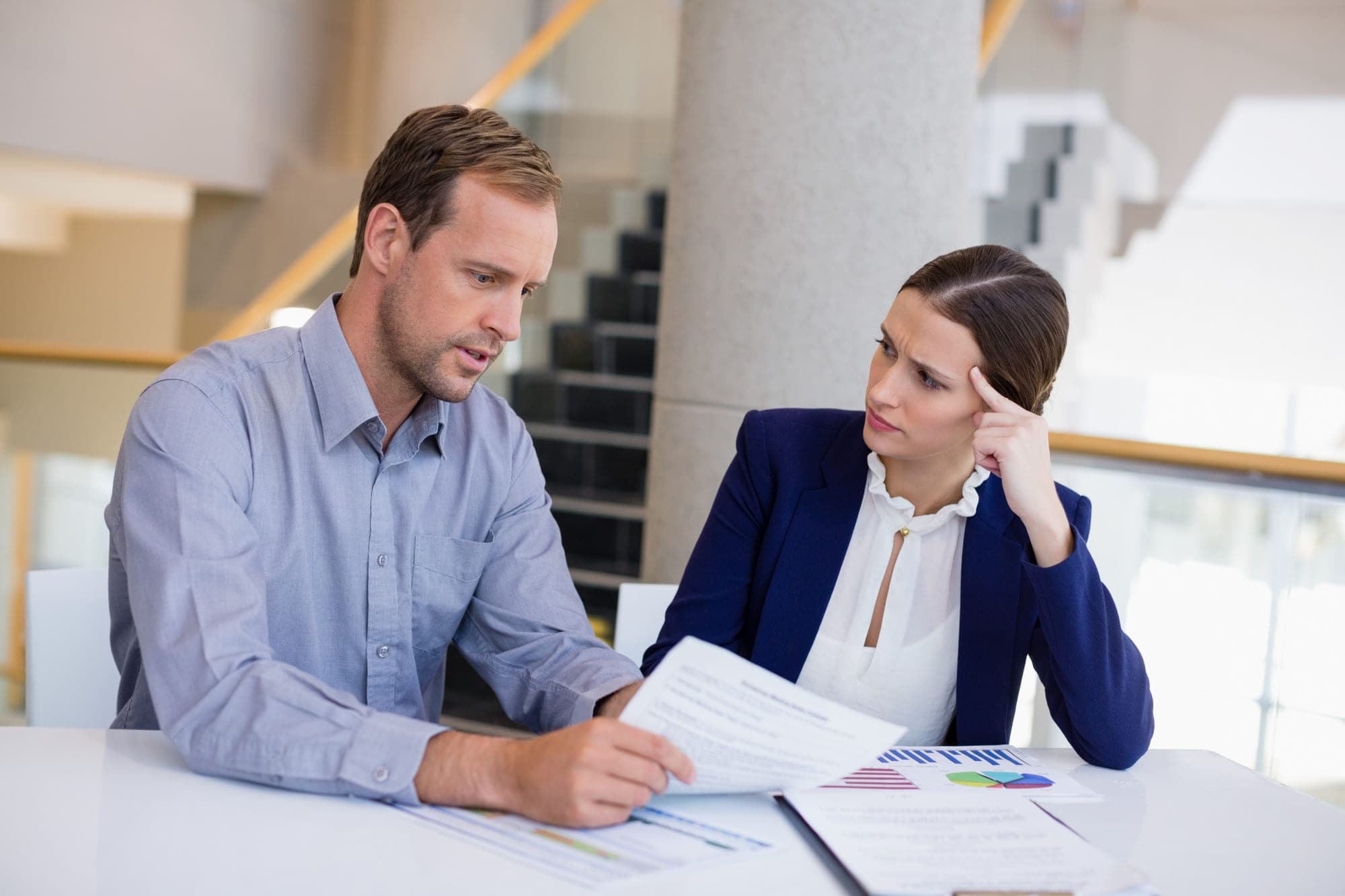 Business professionals discussing trade credit insurance with documents.